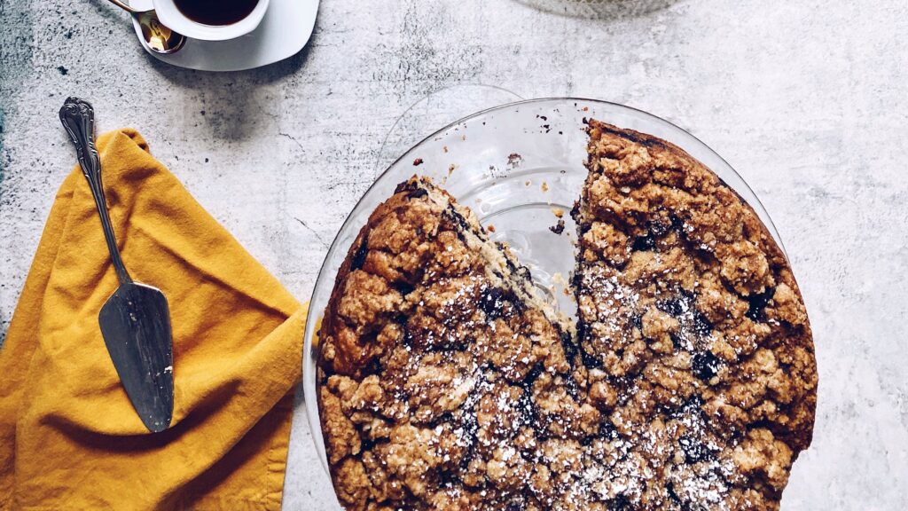 blueberry cake on table with gold napkin