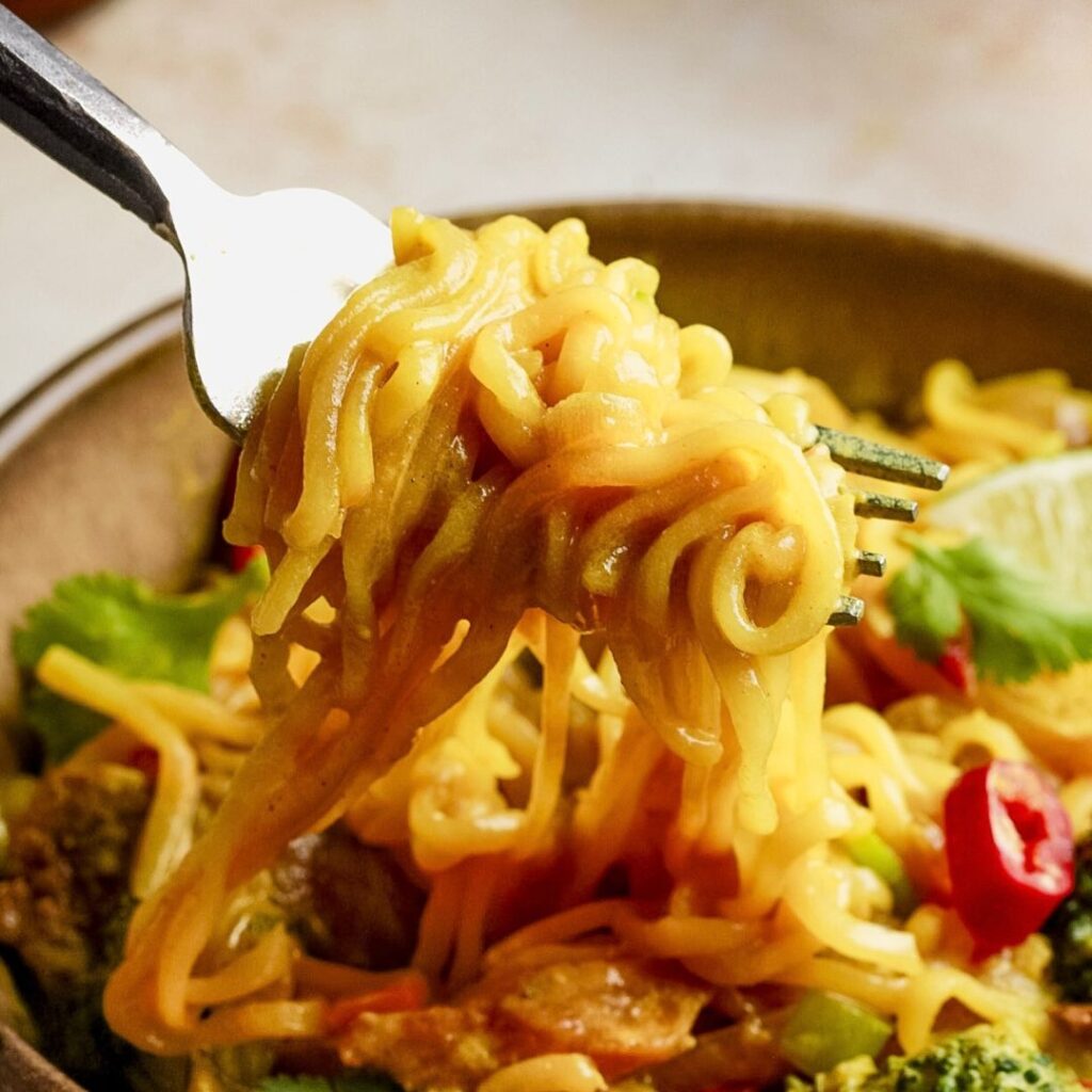 yellow turmeric noodles on a fork