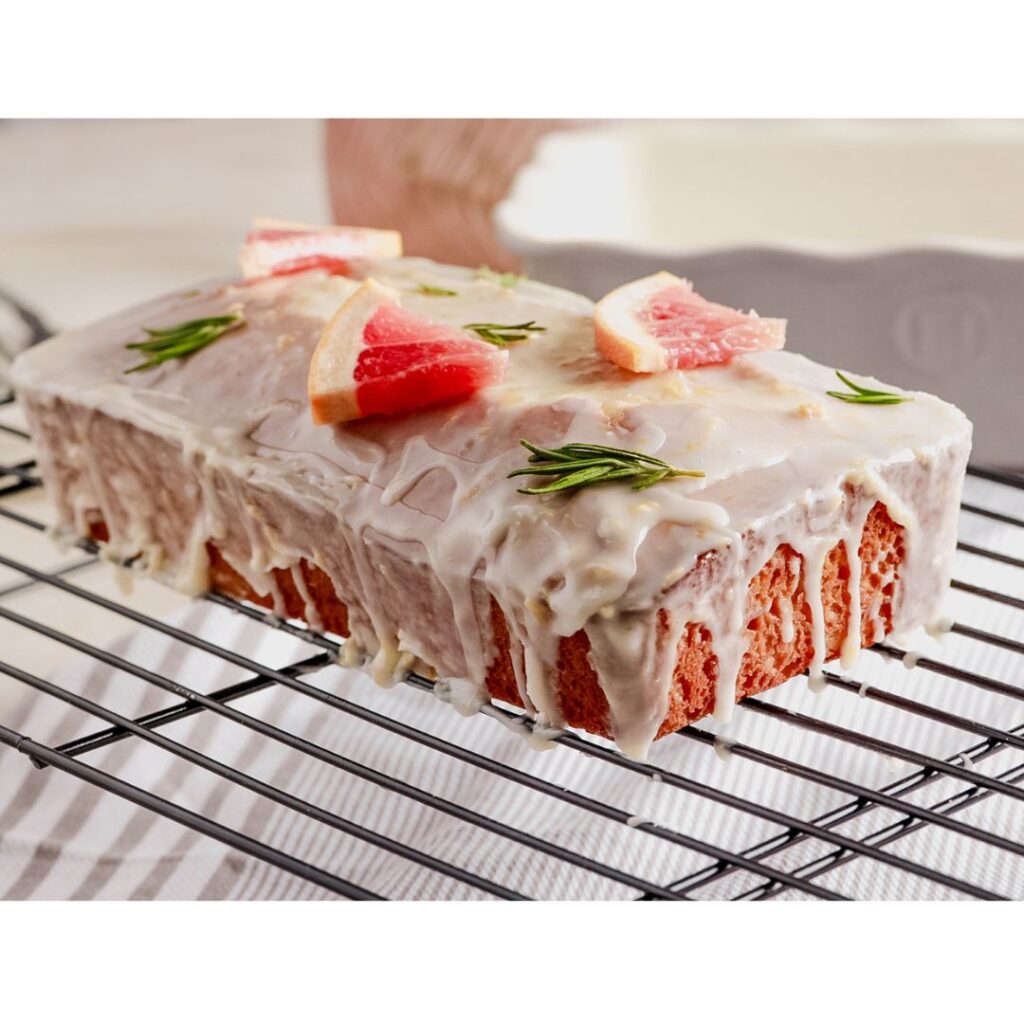 Grapefruite loaf cake on wire rack with grapefruit slices on top